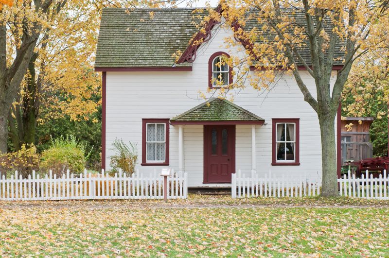 little white house with brown door