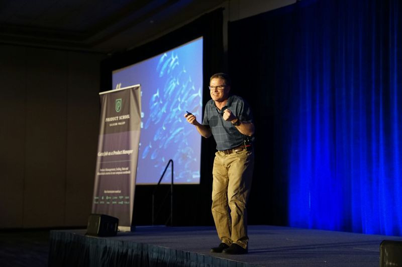 A man presenting on a stage.