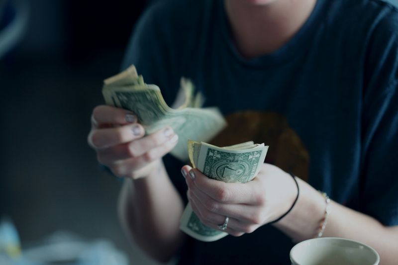 A person counting U.S. Dollar bills