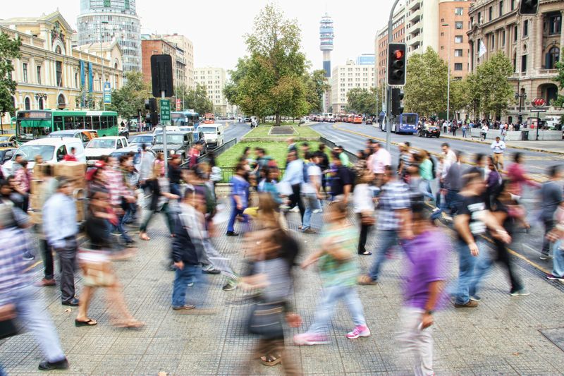 People crossing a busy city street.