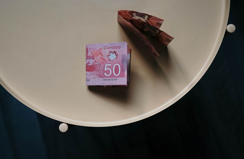 A few Canadian $50 bills on a table