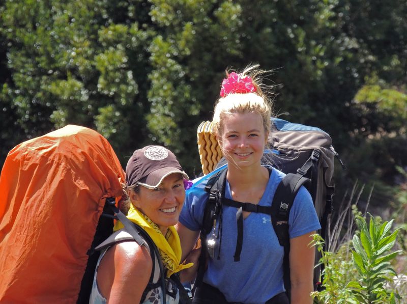 Two women hiking with their packs.