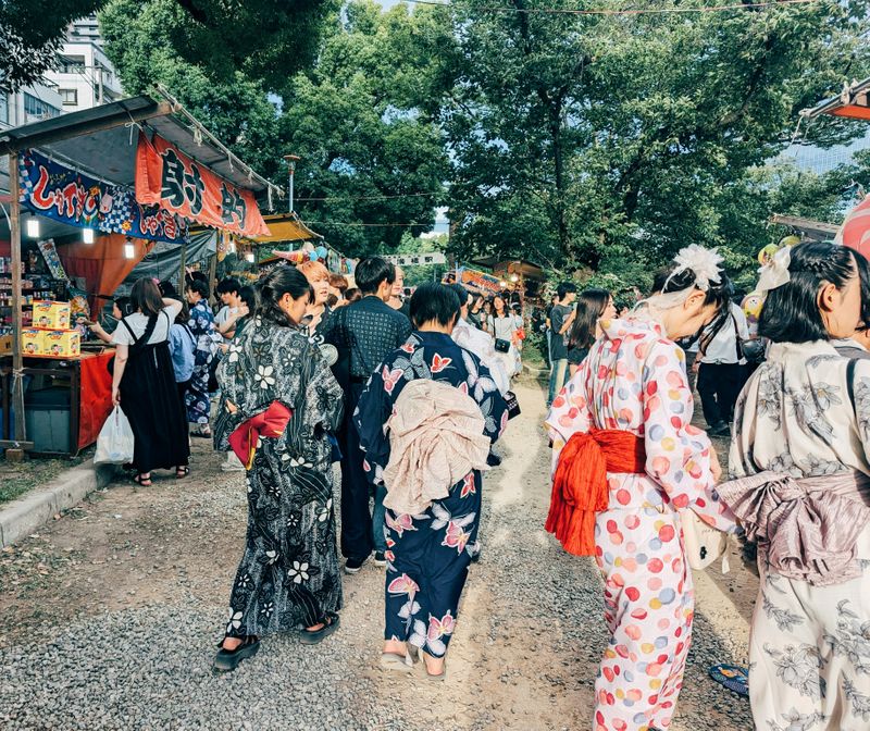 Japanese people wearing kimonos during a festival.