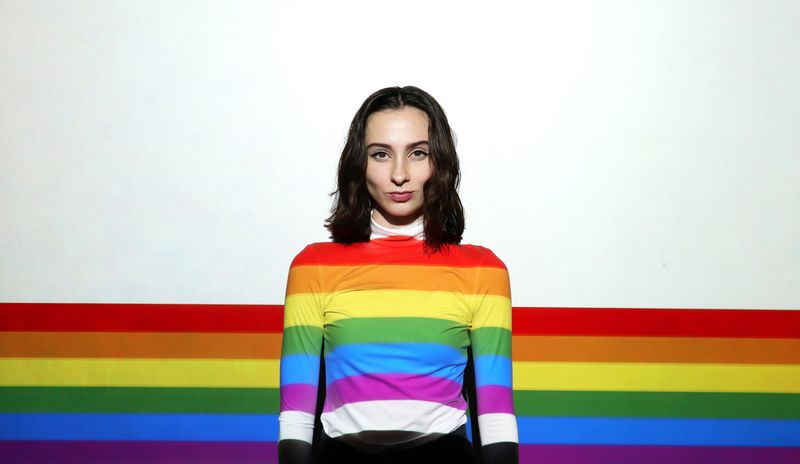 Person with the rainbow straight across their shirt and onto the white background