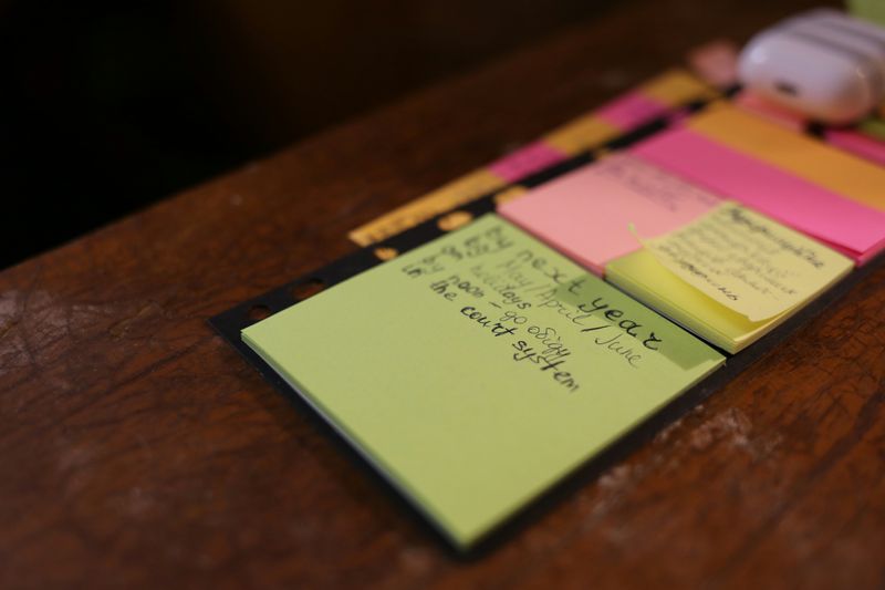 Colorful sticky notes on a desk with handwritten to-do lists and goals.