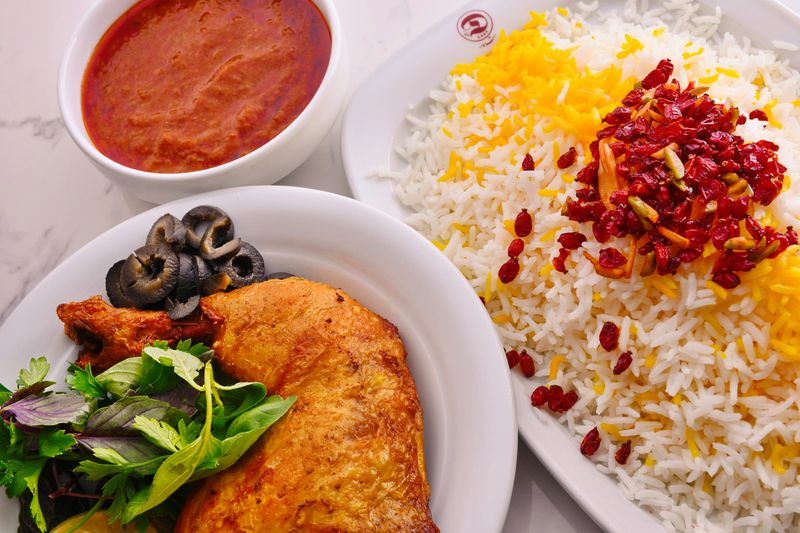 Image of 'Zereshk Polo Ba Morgh', Persian cuisine featuring rice with chicken and barberry.