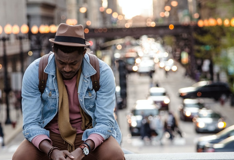 A person sitting with a cityscape behind them.