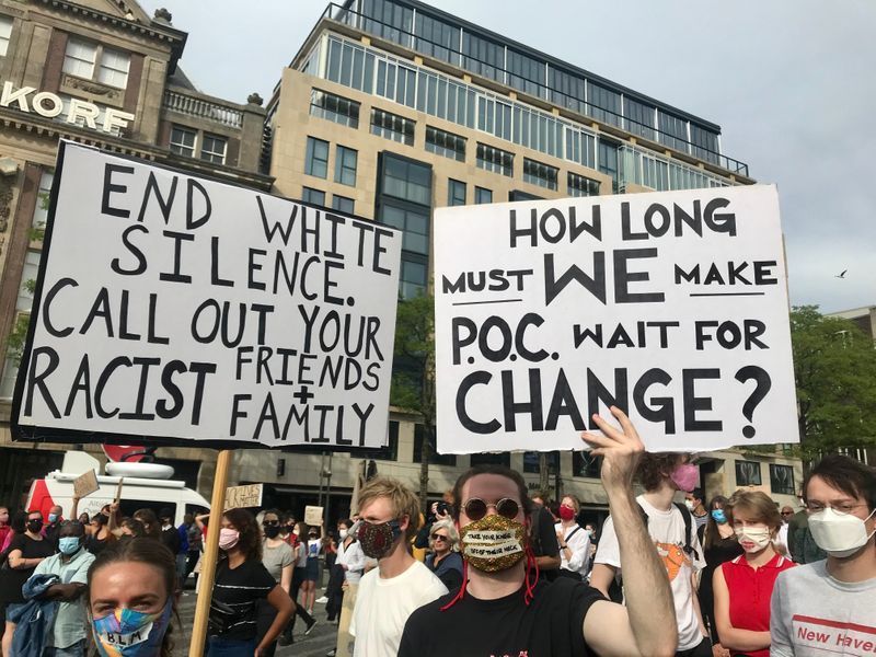 Protestors with signs in favor of ending racial discrimination.