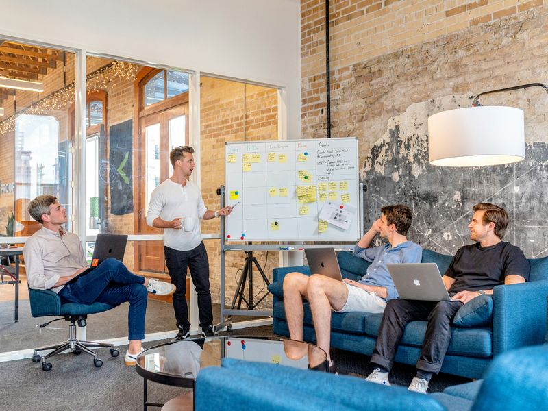 A group of men working on a project in an open office area.