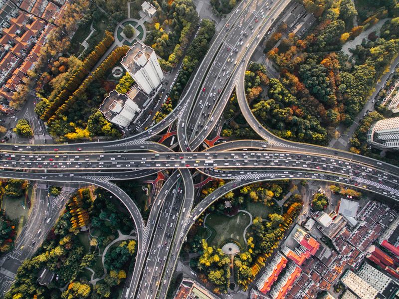 An aerial view of a highway running through a city