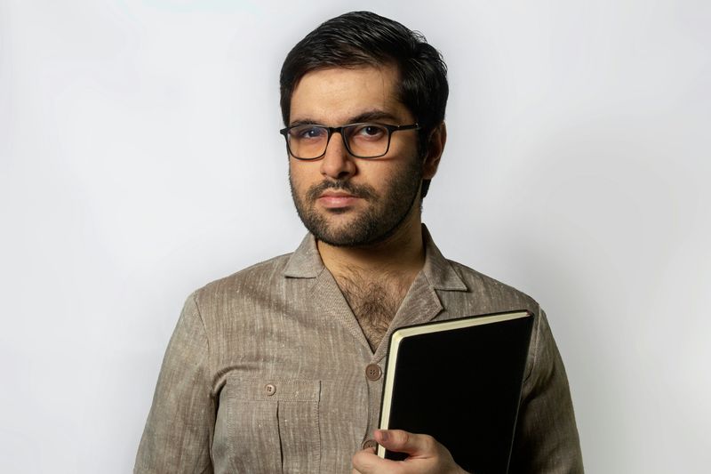 Male teacher holding a notebook