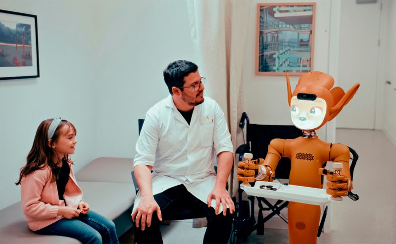 Man and child in doctor's office looking at a robot holding a tray
