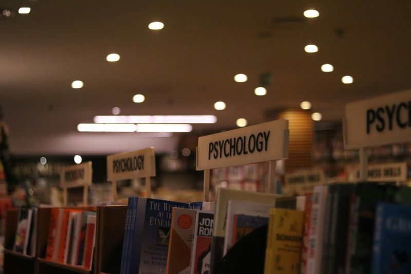 A bookshelf in a bookstore marked 'Psychology'.