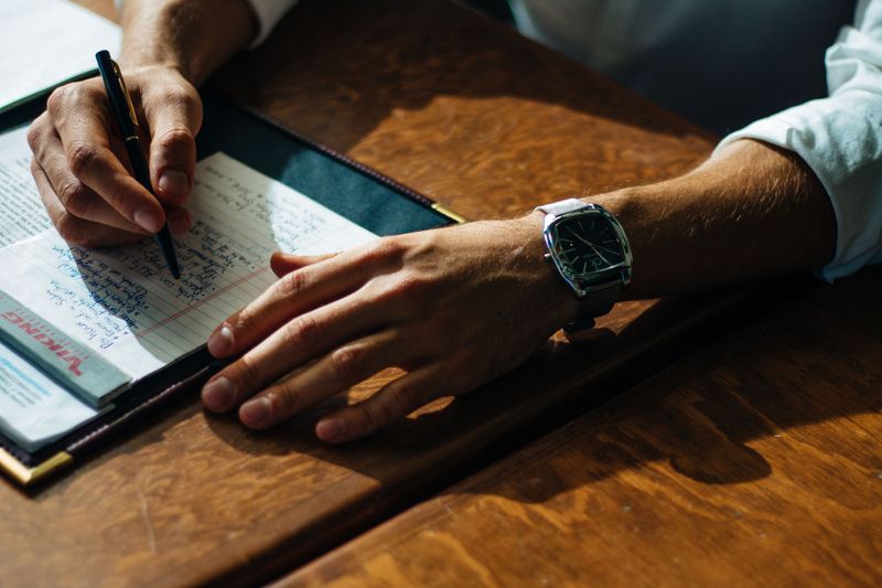 A person talking notes at a desk.