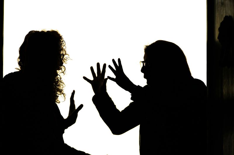 A mother and teen daughter arguing with each other.