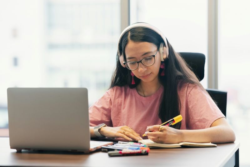 A woman working on a laptop computer. 