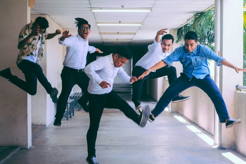 A group of young adults jumping in joy.