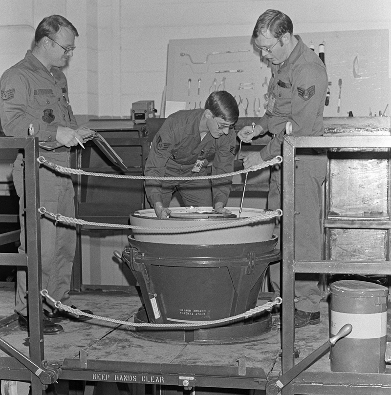 US Air Force personnel installing a missile warhead.