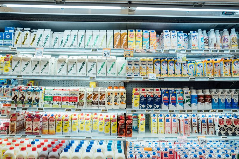 Shelves at a grocery store stocked with milk products.