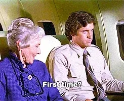 Elderly lady asks young man if it is his 'first time' being on a plane.