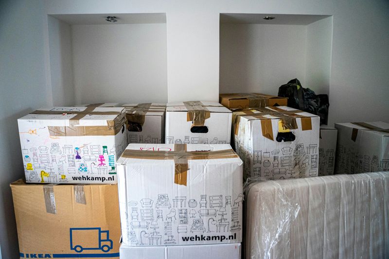 Moving boxes filling a room.