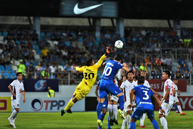 Action shot of a football match with two players competing for the ball.