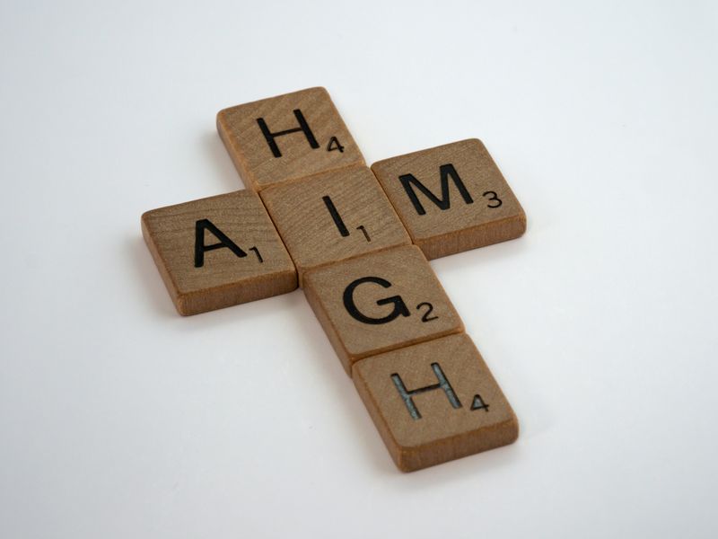 Scribble ties in a cross shape, spelling "Aim High."