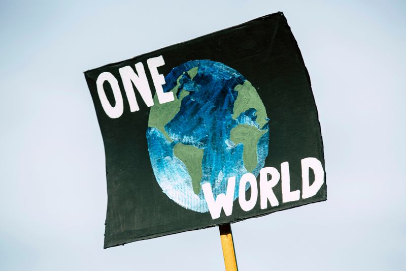 A sign with a picture of the world in the center with the words 