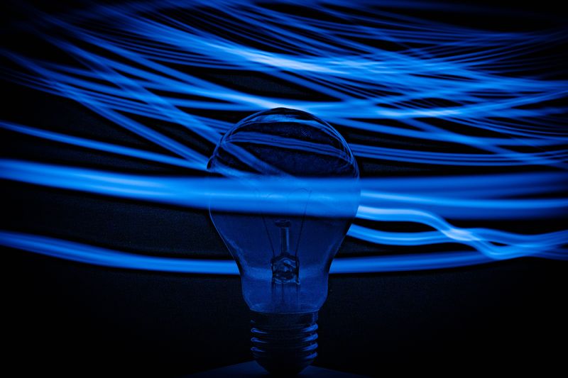 Image of bulb surrounded by the blue colored waves