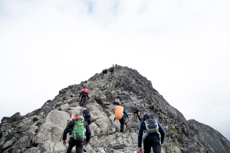 A mountain guide leading others up a mountain.