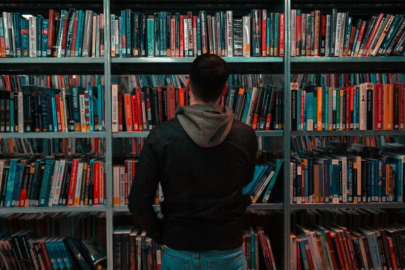 A man browsing books at a library.