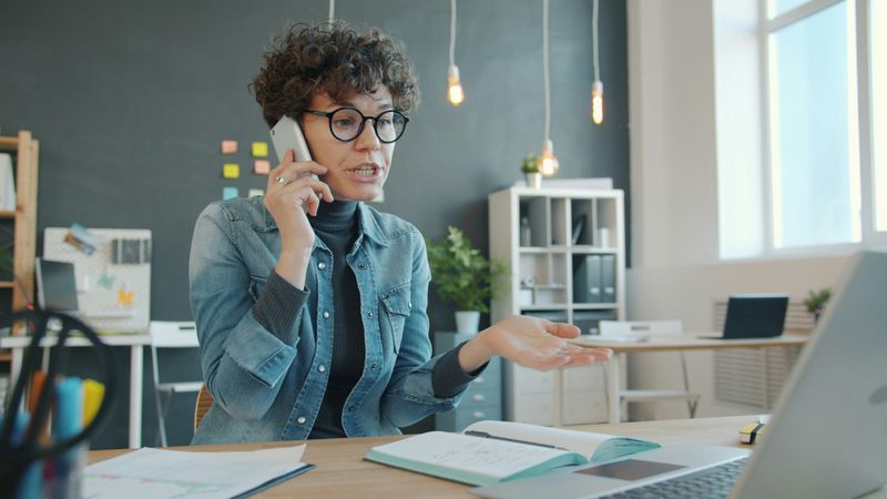 Woman in office speaking on the phone