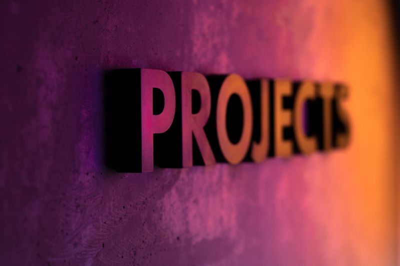 The word 'projects' attached to a wall in raised letters.