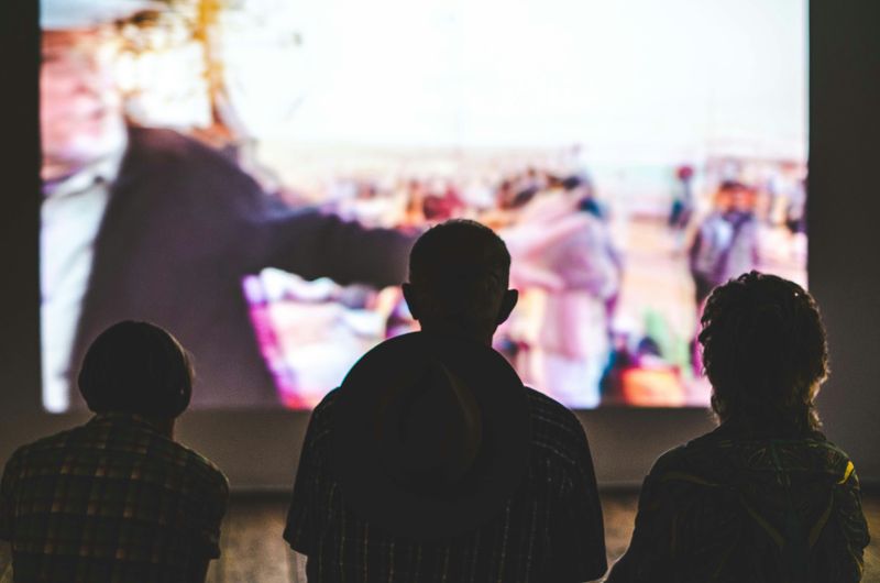 A group of students watching a film in a lecture hall.