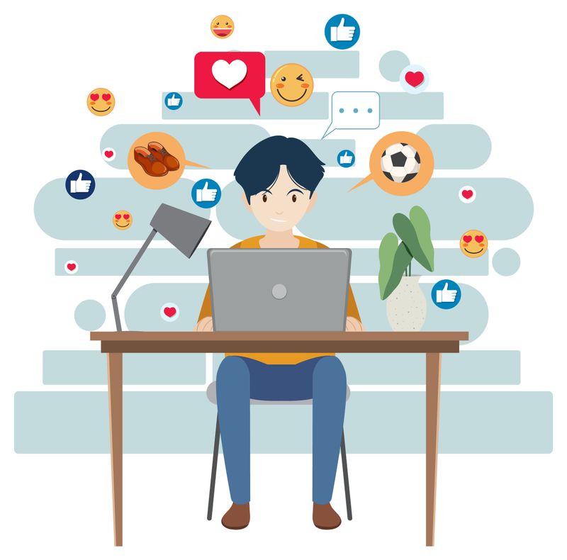 A man at a desk communicating through social media on his laptop.