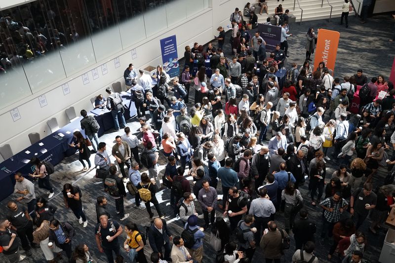 A conference refreshment break with a lot of people talking to each other.