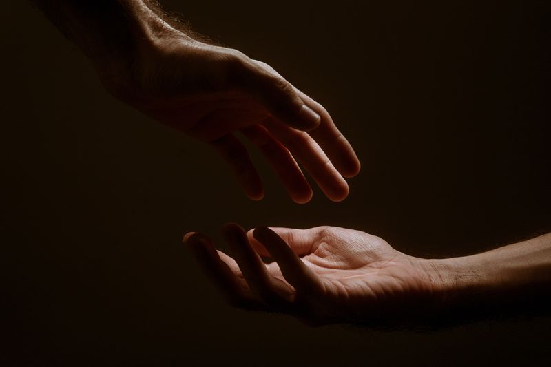 Hands reaching out to touch one another