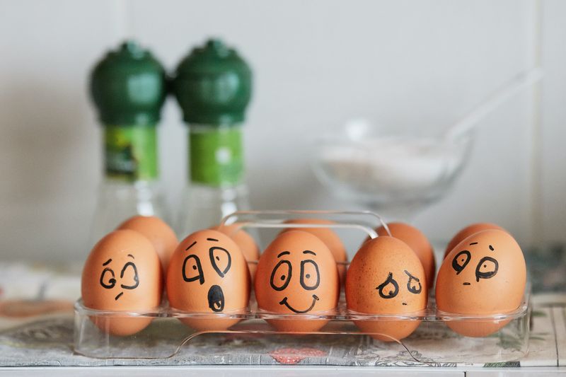 Eggs with different facial expressions drawn on them.