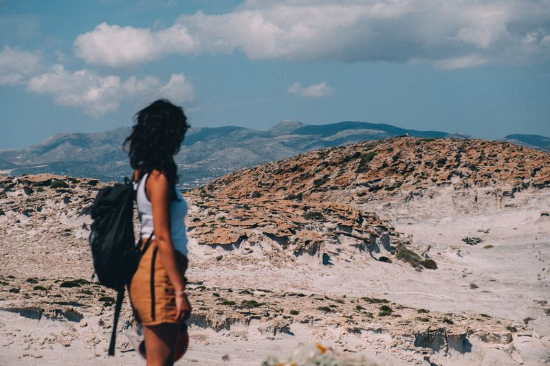 A traveller admiring a mountain landscape.