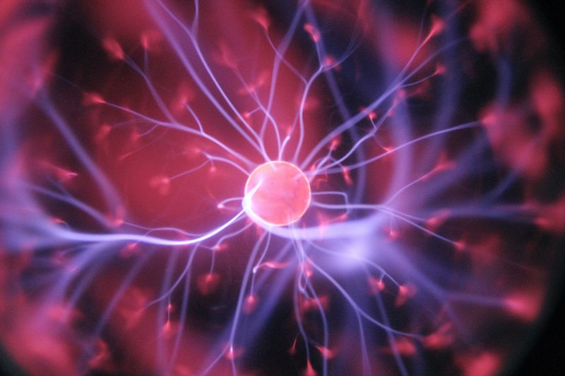 Neuron firing in the brain, visually similar to bolts of lightning emanating from a planet 