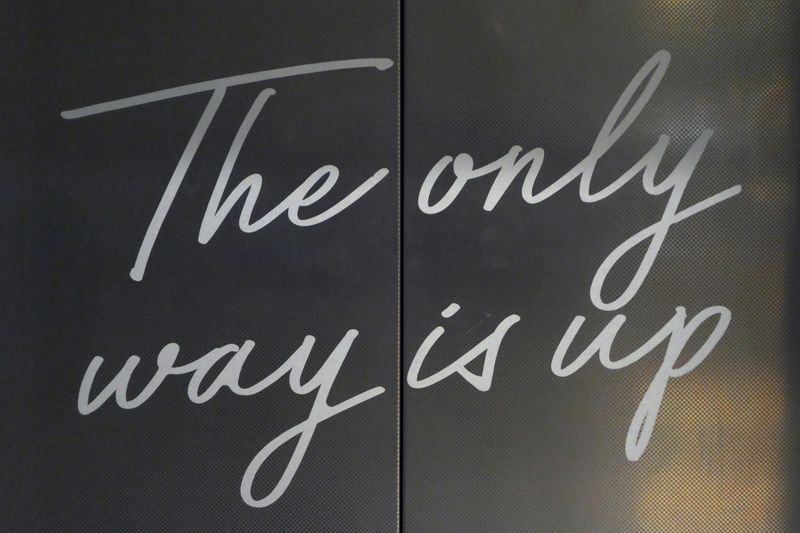 A sign with the words 'The only way is up' written in stylized cursive.