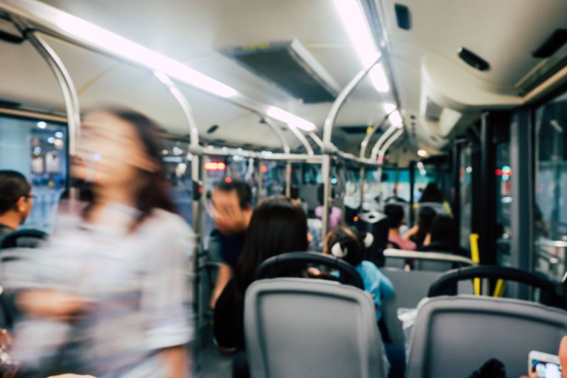 The inside of a crowded commuter bus.