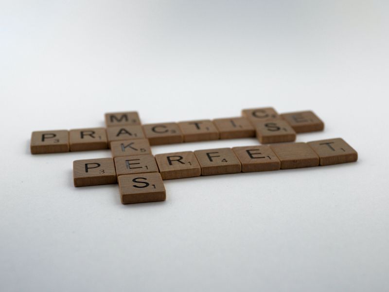 Scrabble square forming the words, Practice makes perfect.