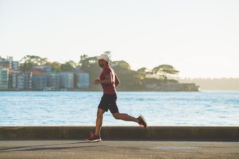 A man running along a water pathway.