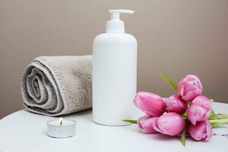 towel, candle, bottle, pink flowers