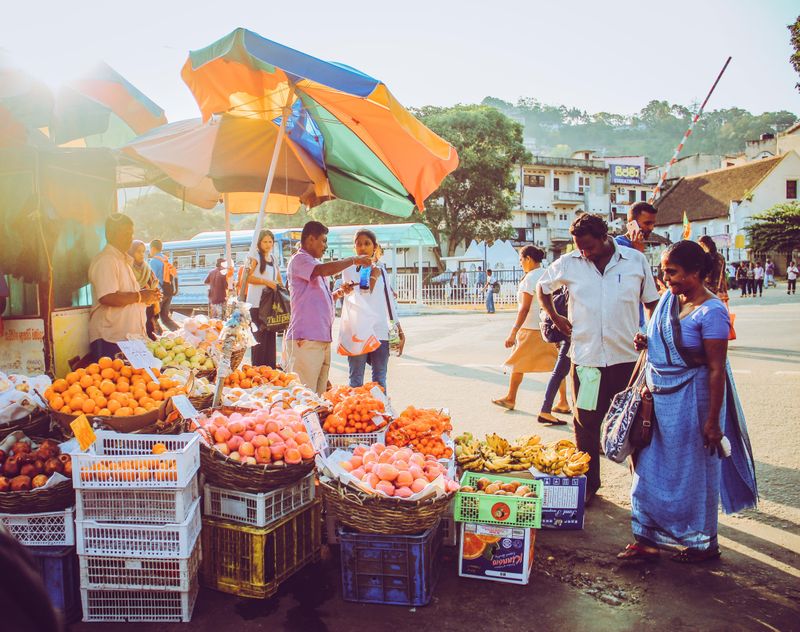people are shopping in an outdoor market