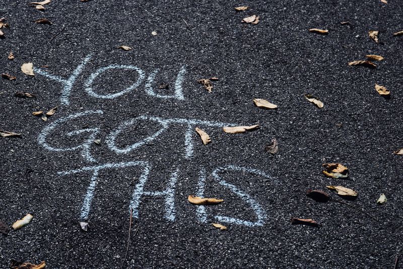 There is some chalk writing on the ground that says, 'You got this'
