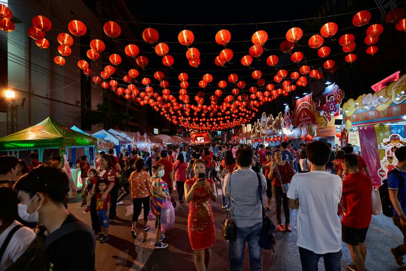 A Chinese night market with red lanterns hanging along the street.