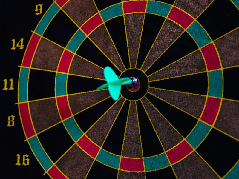 A dartboard with a dart in the bullseye. 