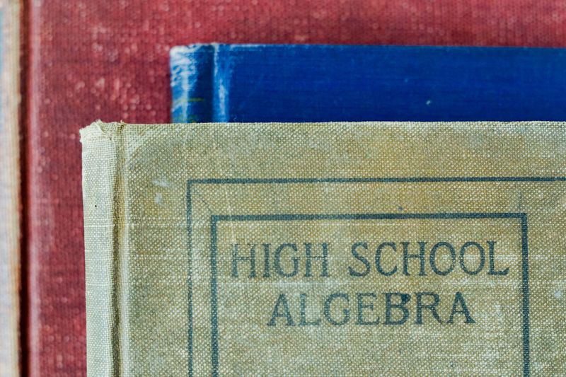 Old books, one that says 'High School Algebra'